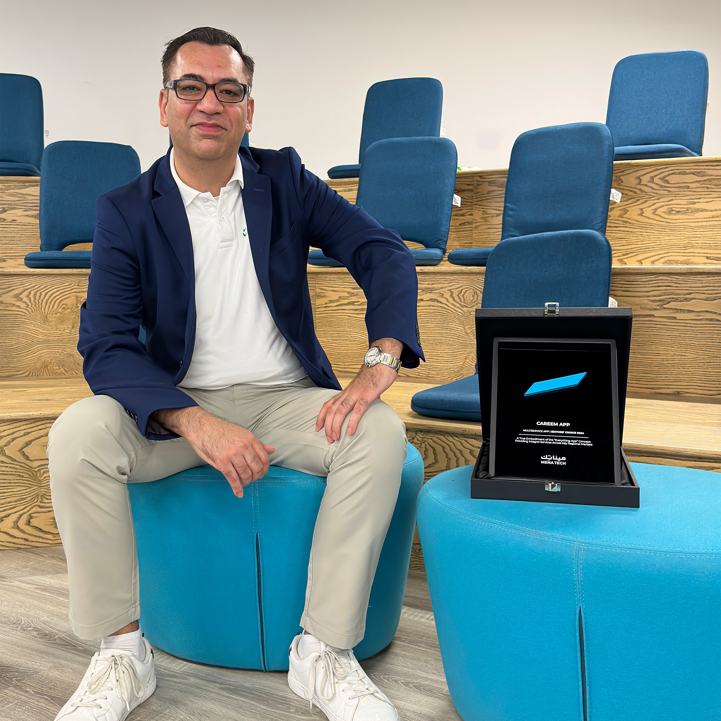 Careem representative sitting next to the MENA Tech Editors' Choice award for the Careem Super App.