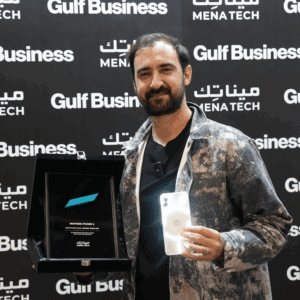 A representative holding the Nothing Phone 2 and the MENA Tech Editors' Choice 2023 award plaque for smartphone design.