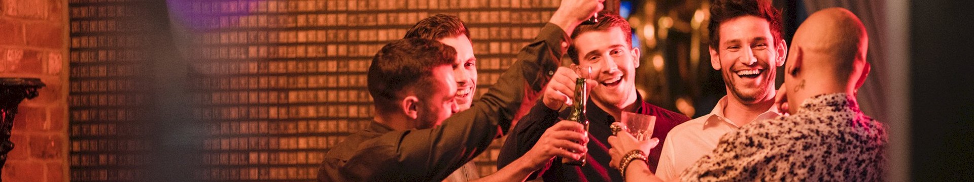 Four men in a club with drinks.