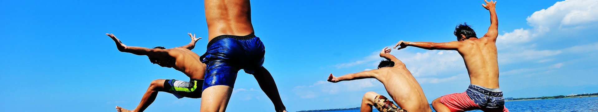 A group of lads jumping into to the on a stag do activity