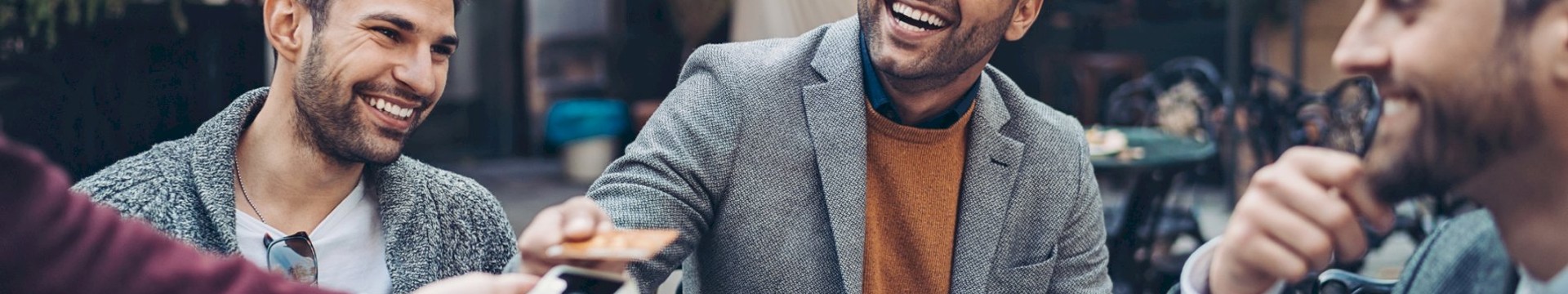 A group of lads on a stag do paying for drinks