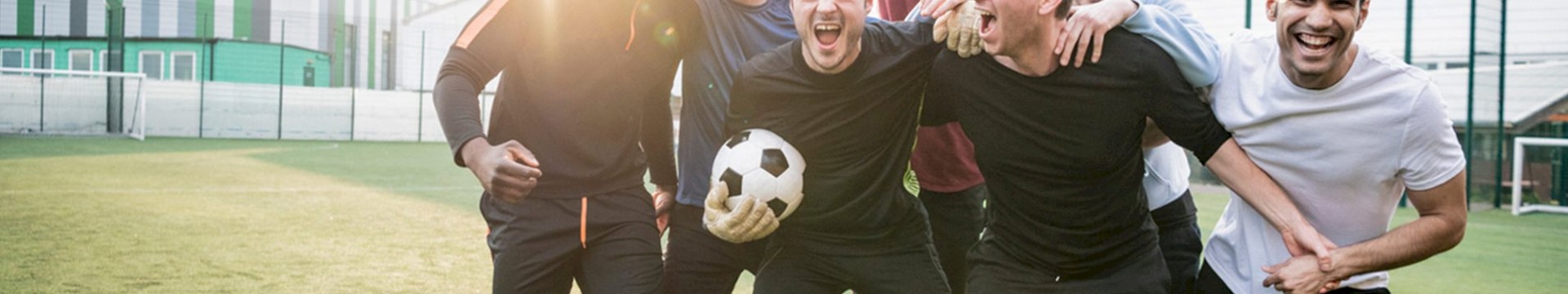 Group of men posing with football 