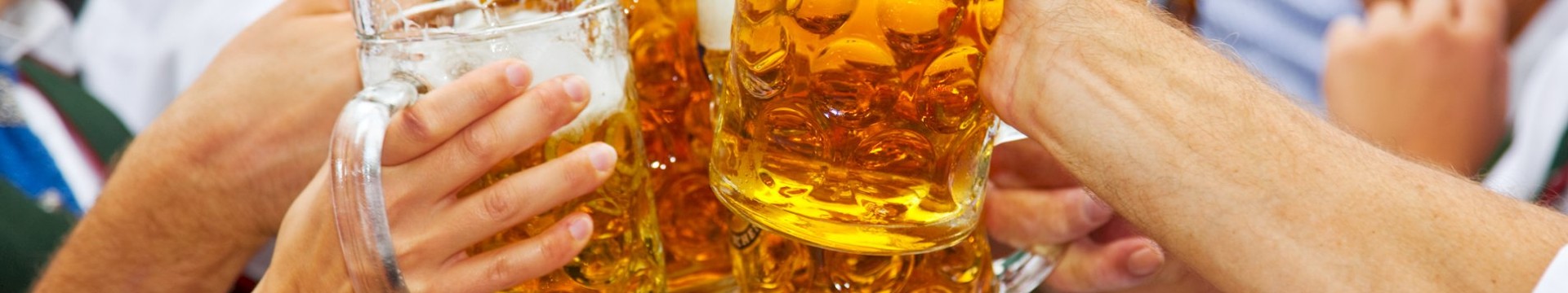 A group of celebrating on a stag do with steins