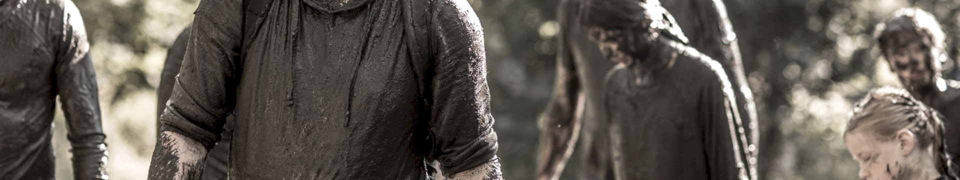 A Group of friends absolutely drenched in mud, after completing in a stag do zombie swat training experience