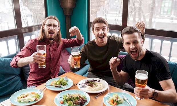 Three men enjoying beers and brunch.