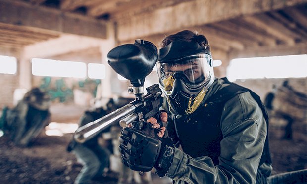 A men in a paintballing uniform 