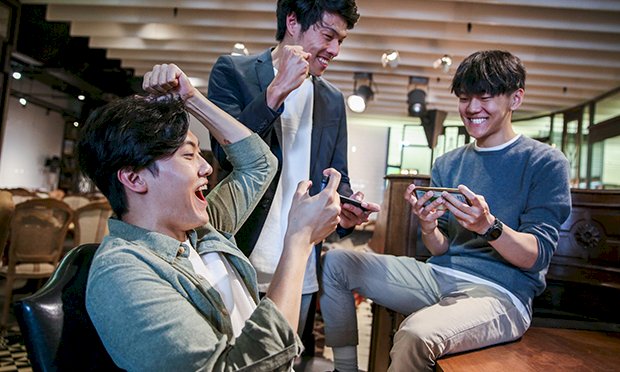 Three men playing games together