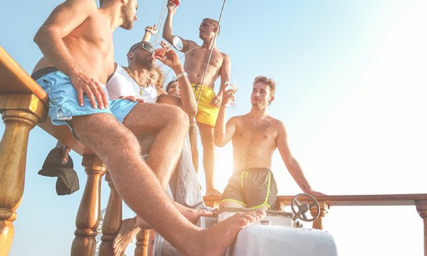 Five men enjoying beers on a party cruise.
