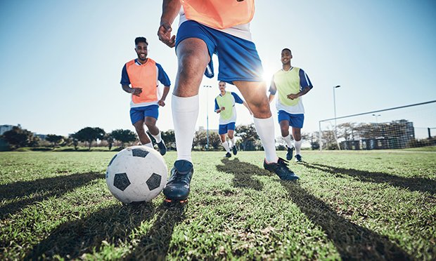 Lads kicking a football.