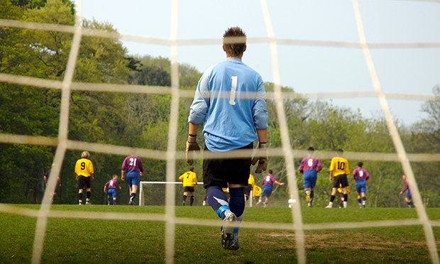 An image of a group of men playing 5 a side football.