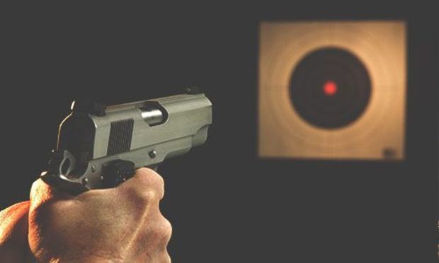 Pistol aiming at a target