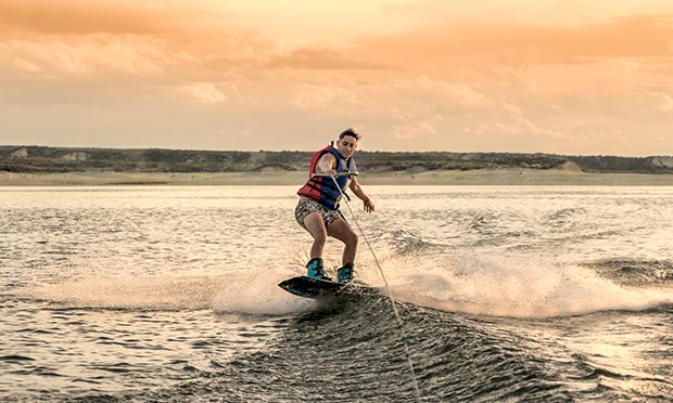 A man wakeboarding in the sea.