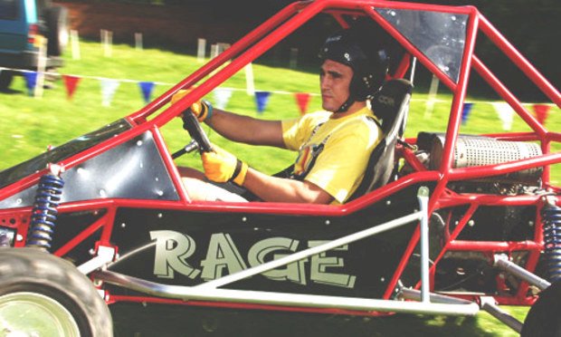 A man racing in a rage buggy as an activity in his stag weekend