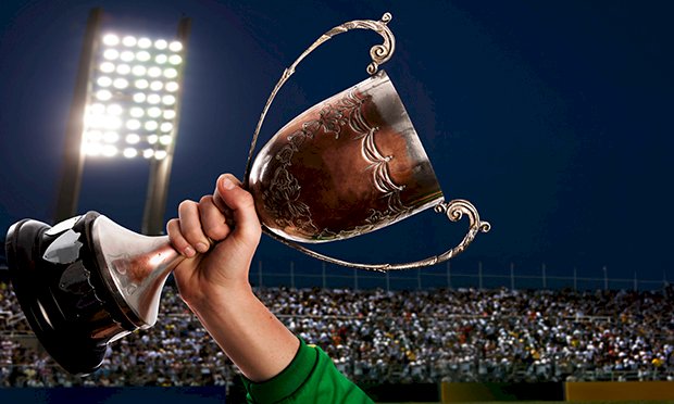 A trophy being held in the air.