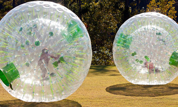 Friends zorbing on a stag weekend