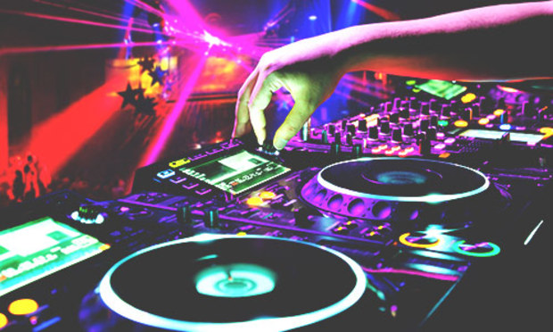 DJ at the decks of a club with a laser light show. Discover the Lincoln Nightclub Entry experience for stag parties: