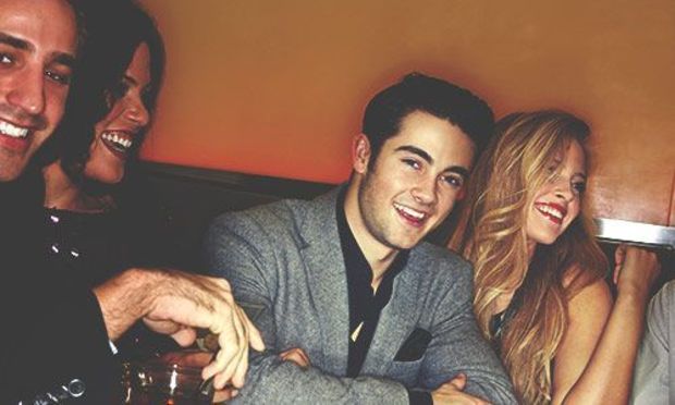 two ladies and two males enjoying drinks