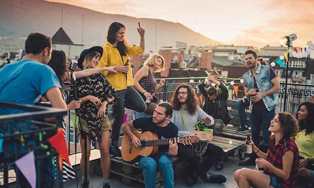 A group of men listening to live music from a band