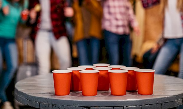 Red cups in a triangle ready for beer pong.