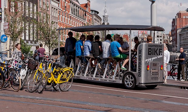 10 males on a joint bike enjoying beers