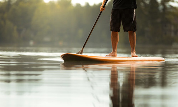 A male paddleboarding