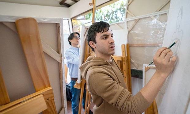 Two men taking part in life drawing on canvas'.