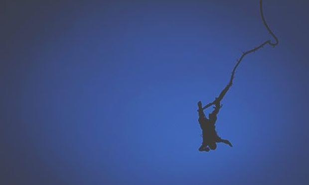 Bungee Jump - Man falling through the air with bungee attached 