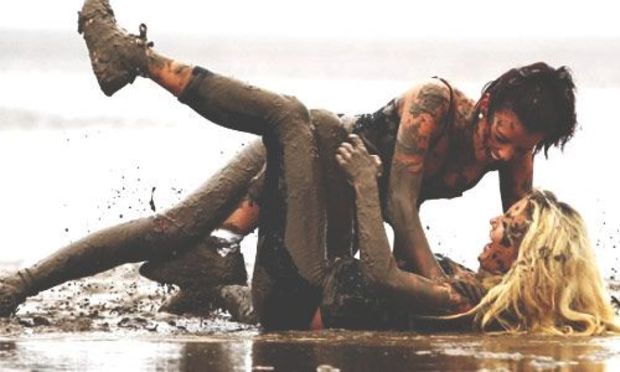 Two girls mud fighting 
