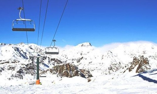 View from under a ski lift in snowy mountains. Discover Andorra Stag Party ideas below: