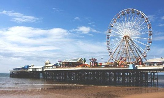 Blackpool pier and amusements on a sunny day. Explore Blackpool Stag Party Ideas below: