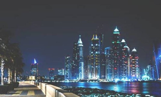 Night view of the Dubai skyline. Explore Dubai Stag Party ideas below: