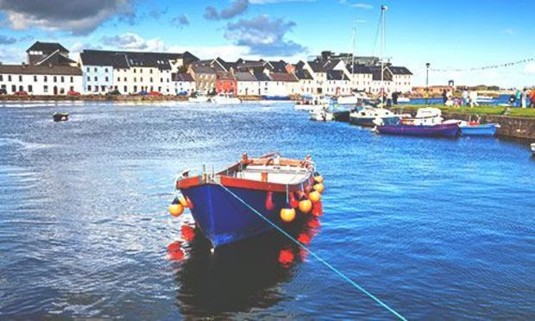 Boat floating down the River Corrib on a sunny day. Discover Galway Stag Party ideas below: