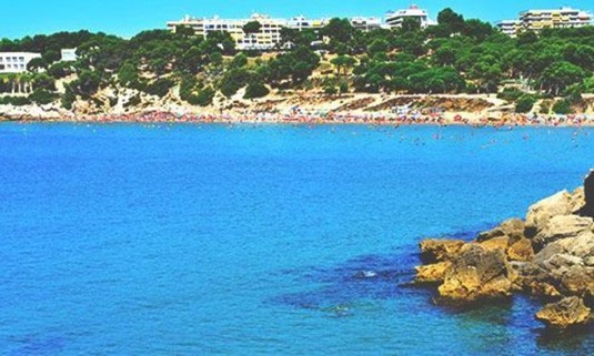 Summer day view of the coast of Salou from the turquoise seas. Explore Salou Stag Party ideas below: