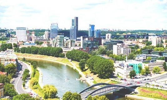 Sunny sights over the Mindaugas Bridge, Neris River and Vilnius. Explore Vilnius Stag Party ideas below: