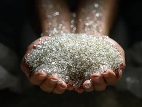 A woman holding plastic pellets 