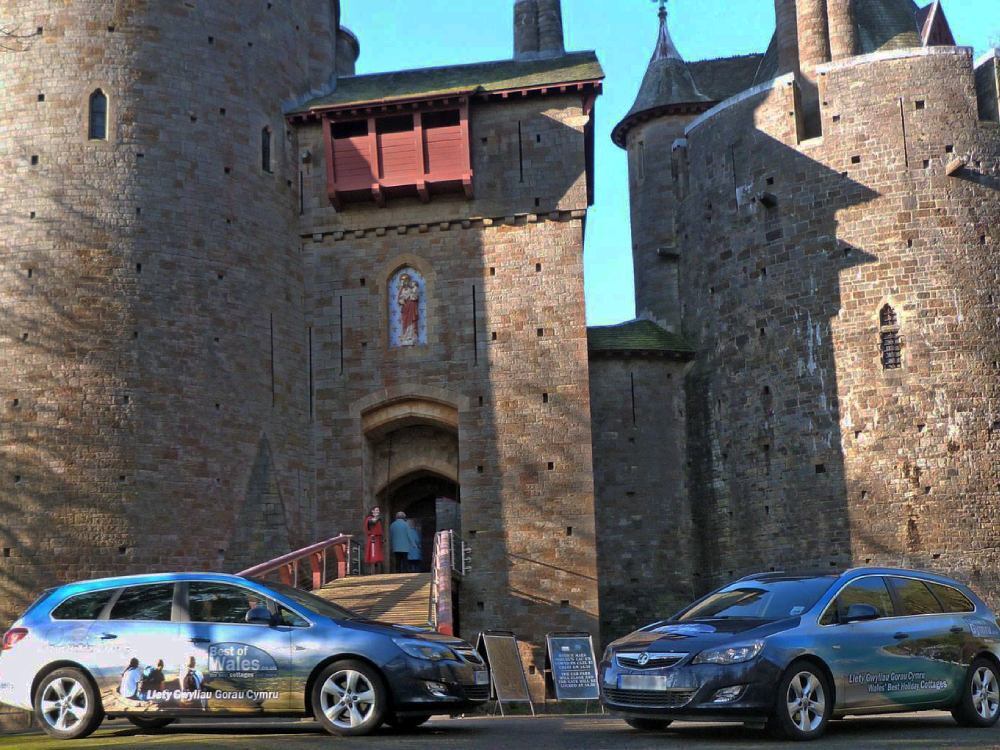 Branded vehicle vinyl wraps on fleet of company cars outside Castell Coch in Cardiff.