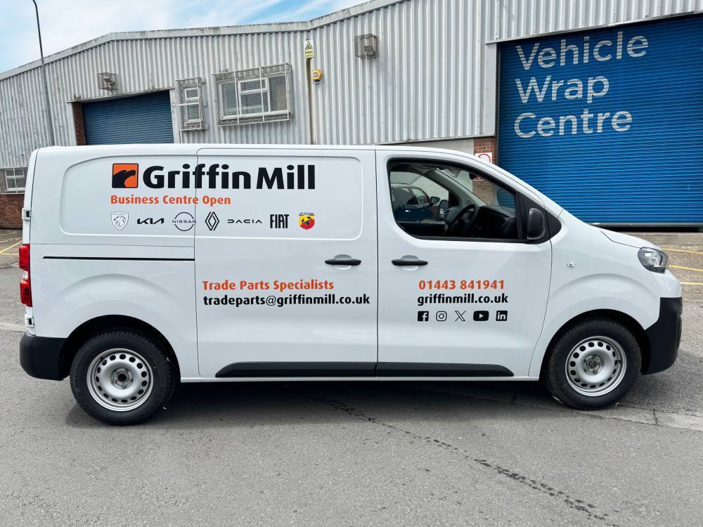 Company advertising vinyl graphics on white company Peugeot Expert van.