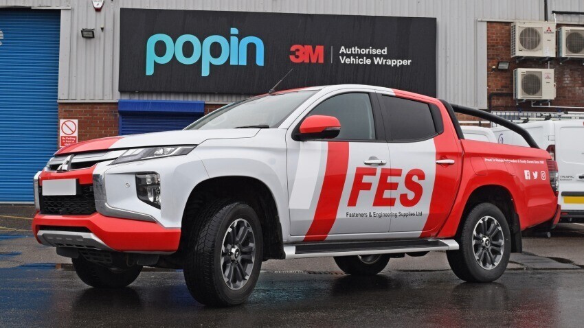 Mitsubishi L200 with new red and white vehicle wrap outside Popin Graphics in Cardiff.