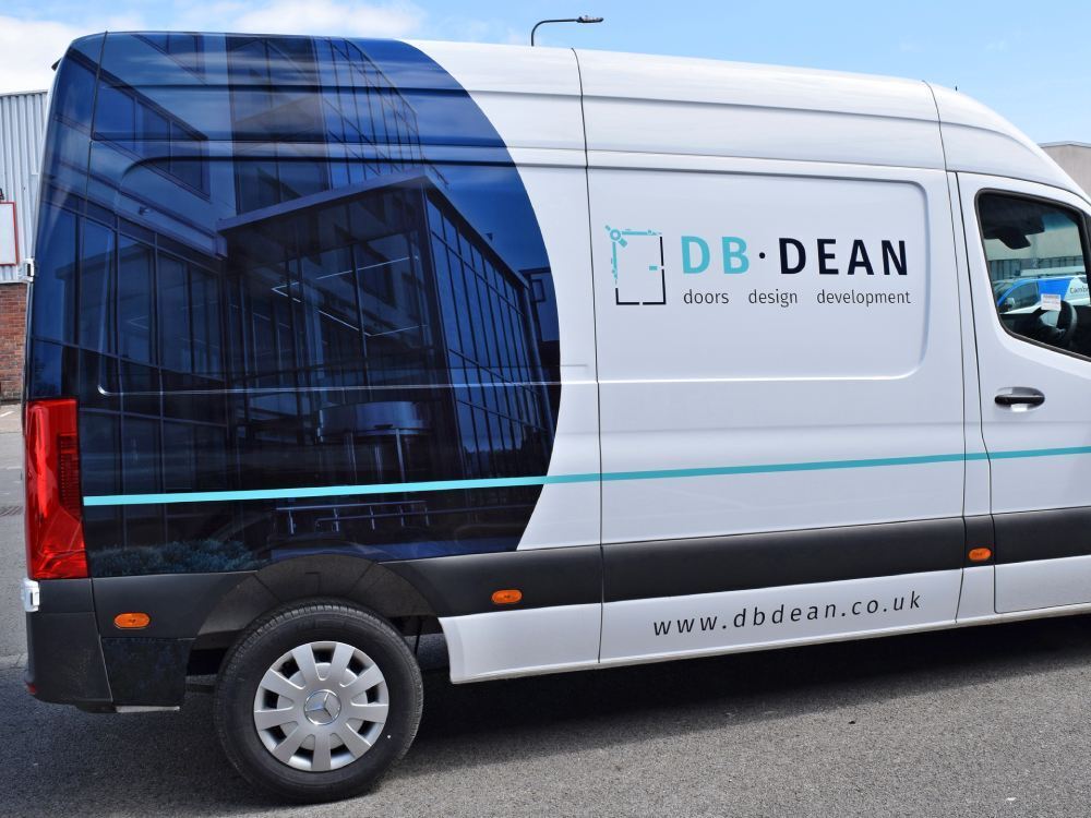 White company Mercedes Sprinter van with partial wrap and vinyl graphics.