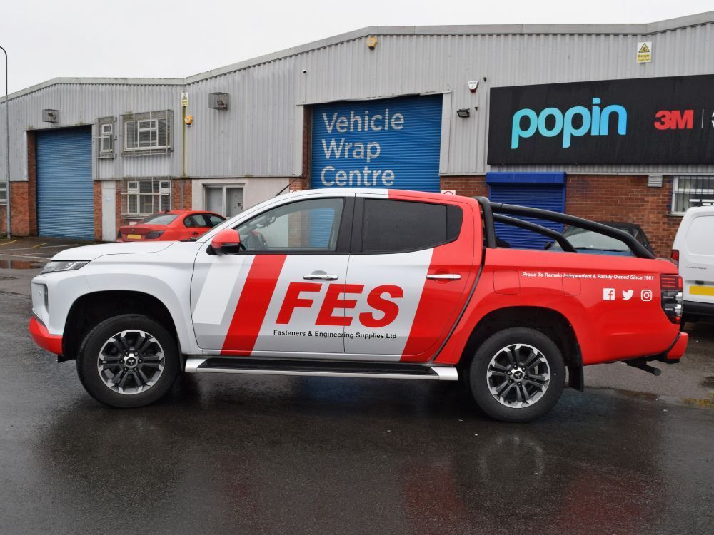Company branded vehicle wrap and graphics on Mitsubishi L200 outside Popin in Cardiff.