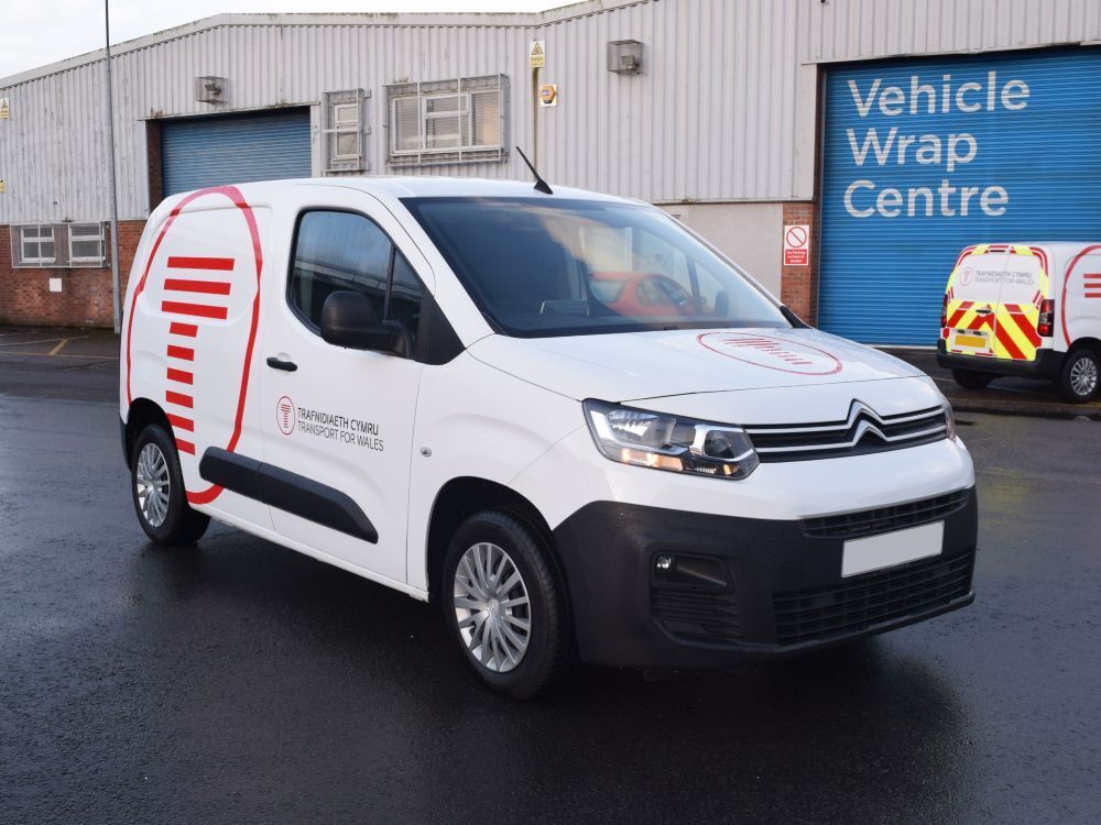 Branded vehicle graphics installed on a white Citroen Berlingo van.