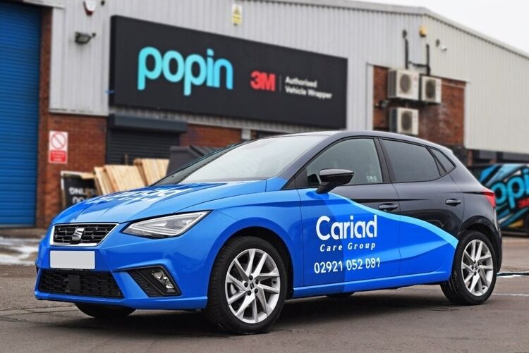 SEAT Ibiza company car with branded vehicle wrap outside Popin in Cardiff.