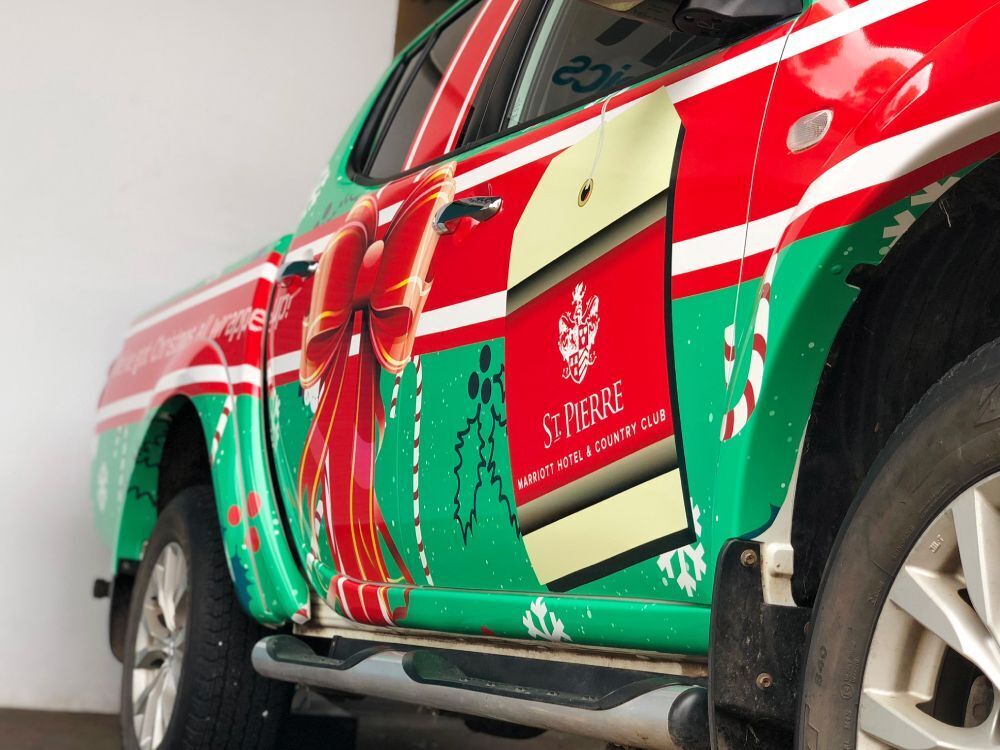 Close up of red and green Christmas livery on Mitsubishi L200.