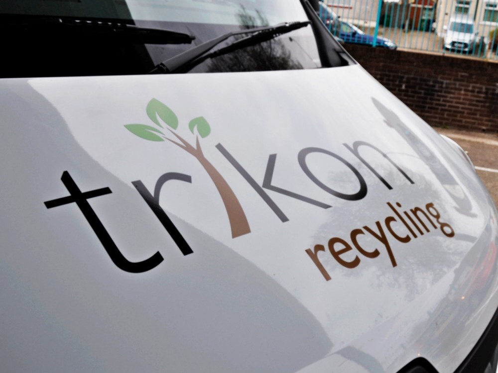 Vinyl wrap on front bonnet of white company Renault Master van.