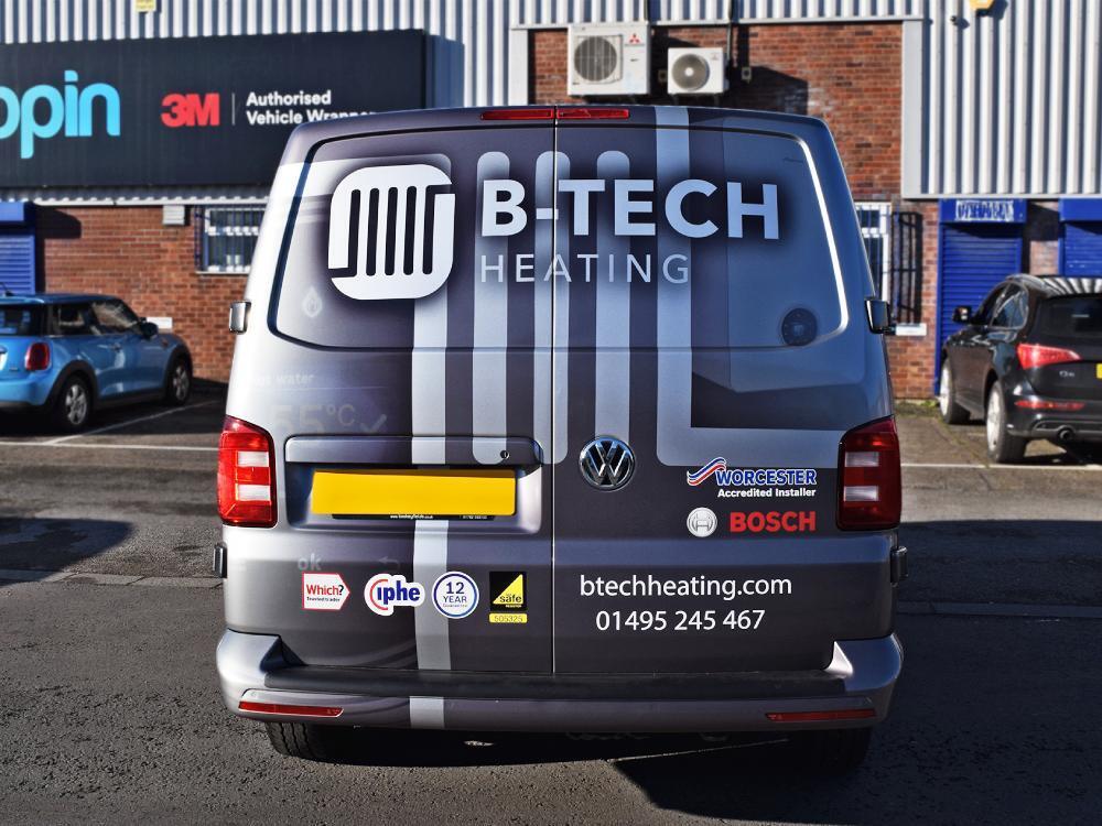 Silver branded company van wrap on Volkswagen Transporter outside Popin in Cardiff.