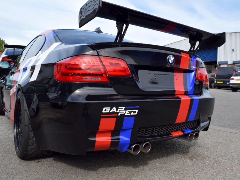 Rear vinyl decals on black BMW E92 M3 race car