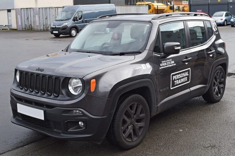 Company branded vinyl graphics installed on grey Jeep.