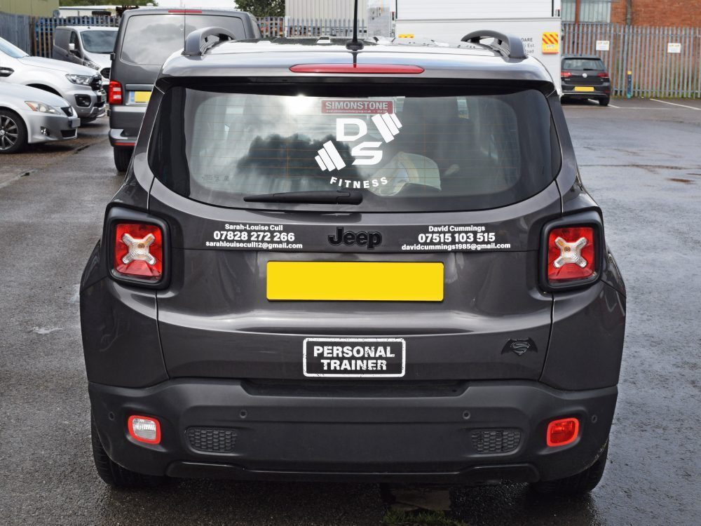 Rear of grey company Jeep with business branded vinyl graphics applied.