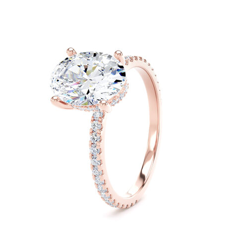 Oval solitaire with diamond set shoulders and hidden diamond detail