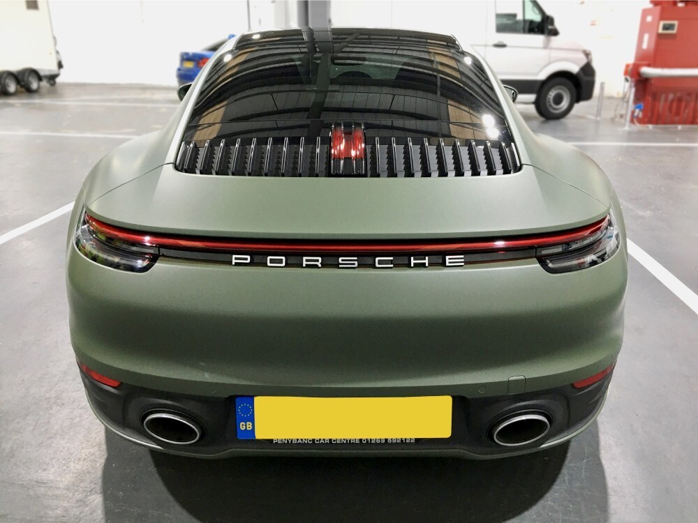 Rear end of Porsche 911 with khaki green matte motorsport livery